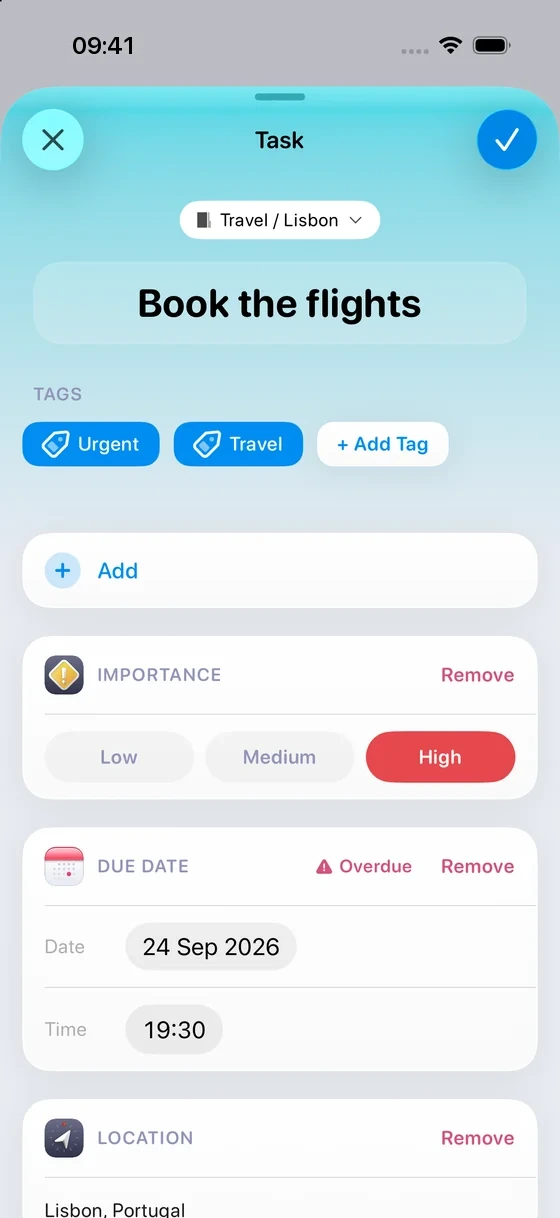 A Task called “Book the flights”, tagged Urgent and Travel, with a Location in Lisbon.